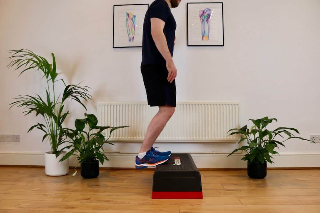 Picture of someone doing a Soleus Stretch off a step