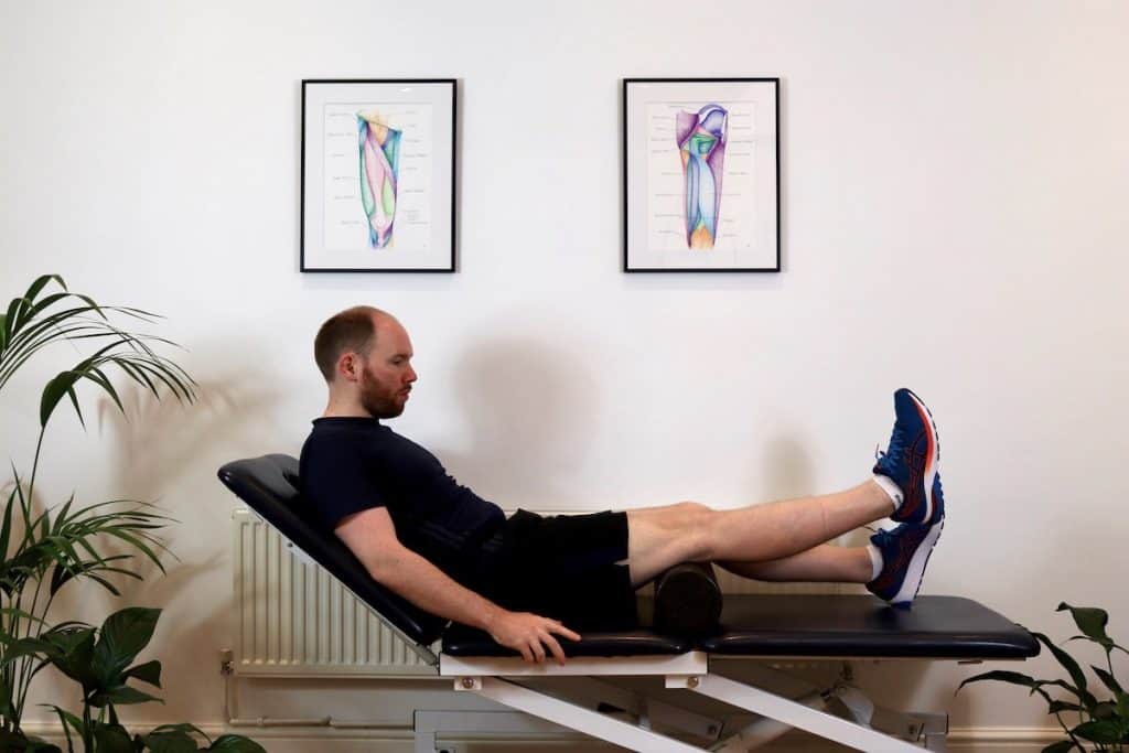 Photo of man doing inner range quadriceps strengthening exercise