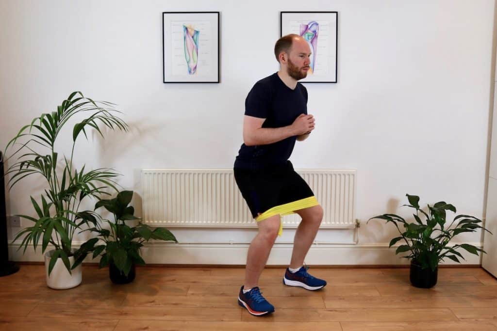 Man doing a shallow squat exercise