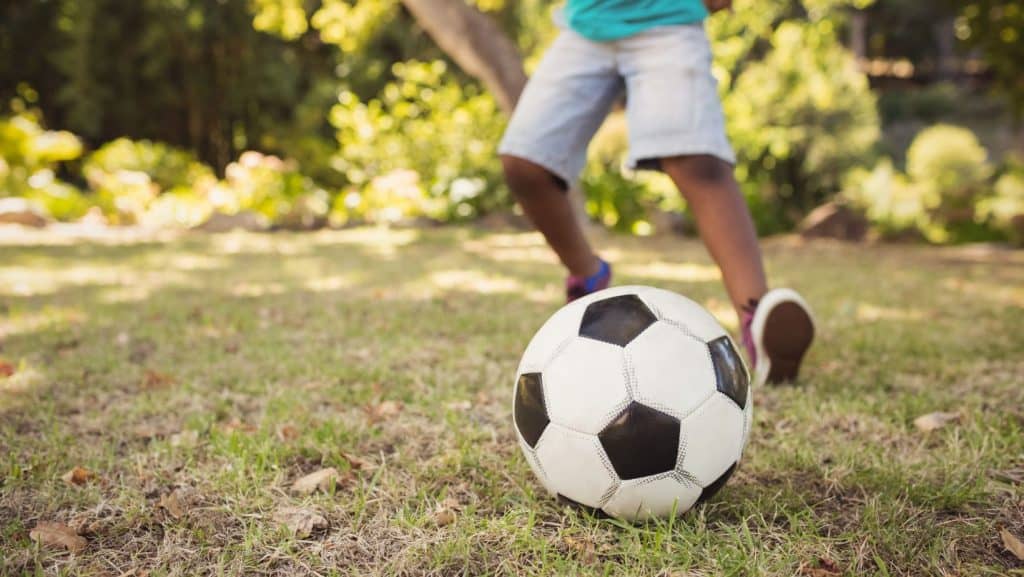 Child playing football after recovering from Sindig Larsen Johansson Syndrome