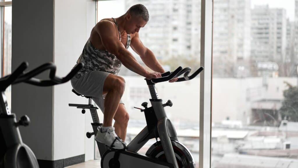 Photo of man cycling on stationary bike for meniscus tear recovery