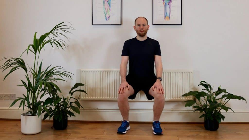 Photo of James McCormack doing a wall sit exercise