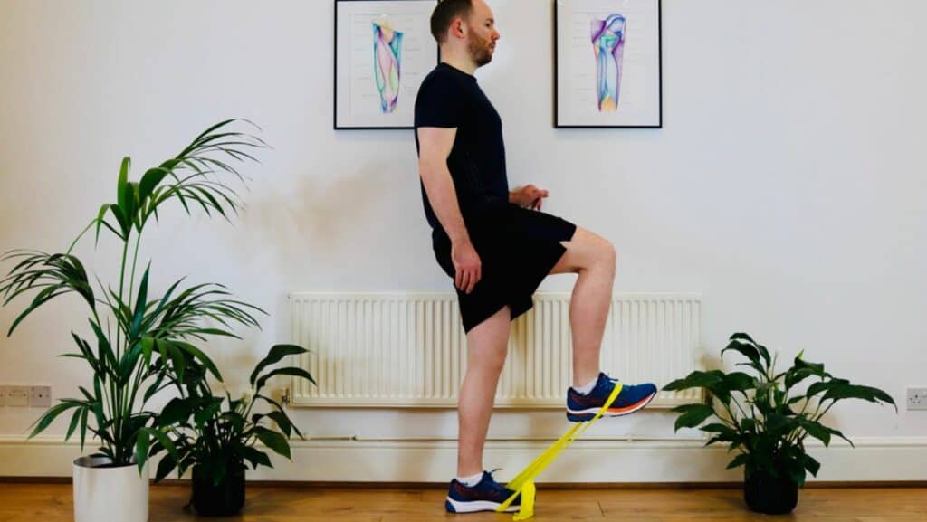 Photo of James McCormack performing hip flexor exercise with bent knee