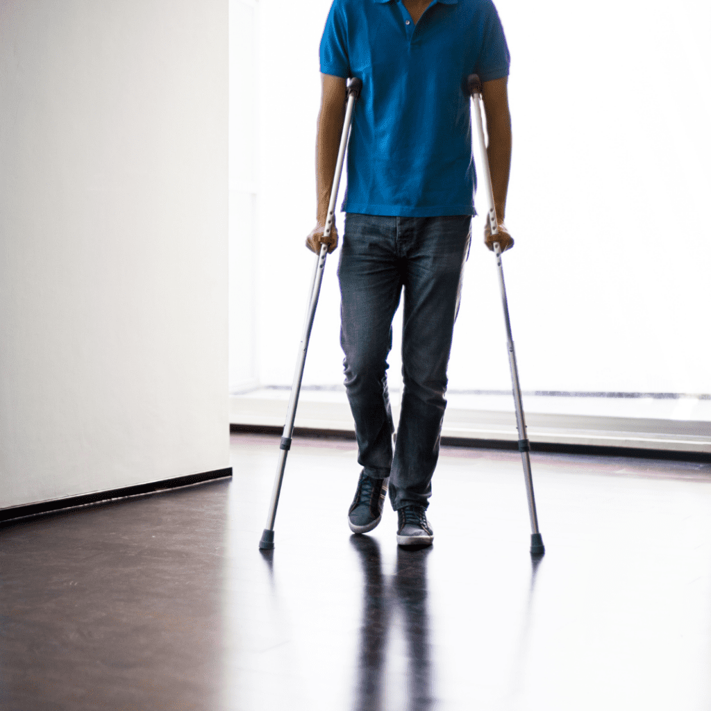 Photo of man walking with crutches